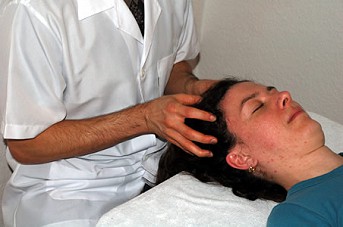 Marcos performing a Facial lift massage as part of a client treatment