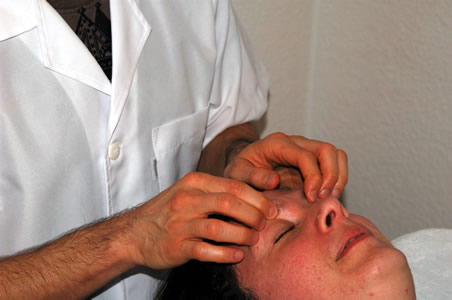 Marcos performing a Facial lift massage as part of a client treatment</perch:content>