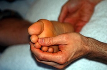 Marcos performing a Reflexology treatment